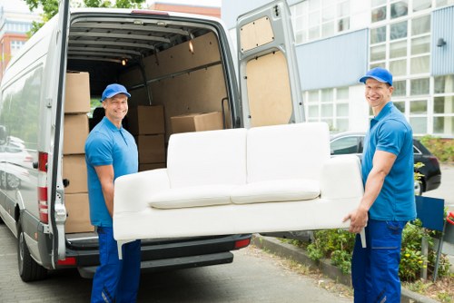 Furniture removals team handling a sofa move in Swiss Cottage