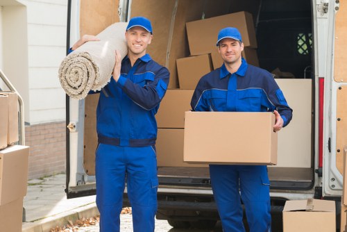 Professional movers loading items for transport in North West London