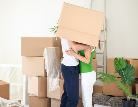 Team carefully moving furniture through a property
