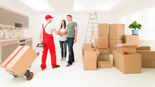 Packed office boxes and furniture prepared for a workplace move in Swiss Cottage